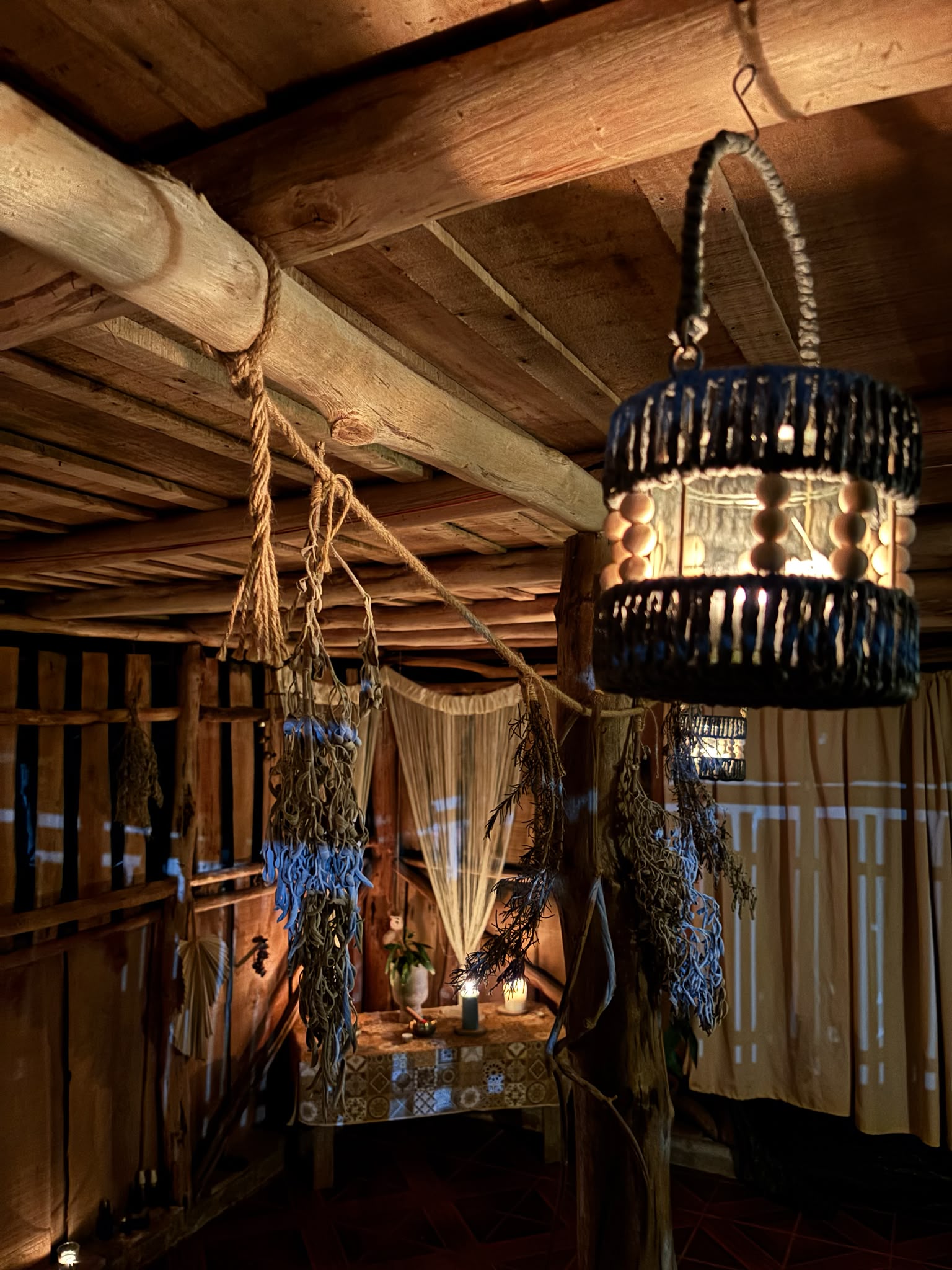 Hanging lantern inside a rustic wooden retreat cabin